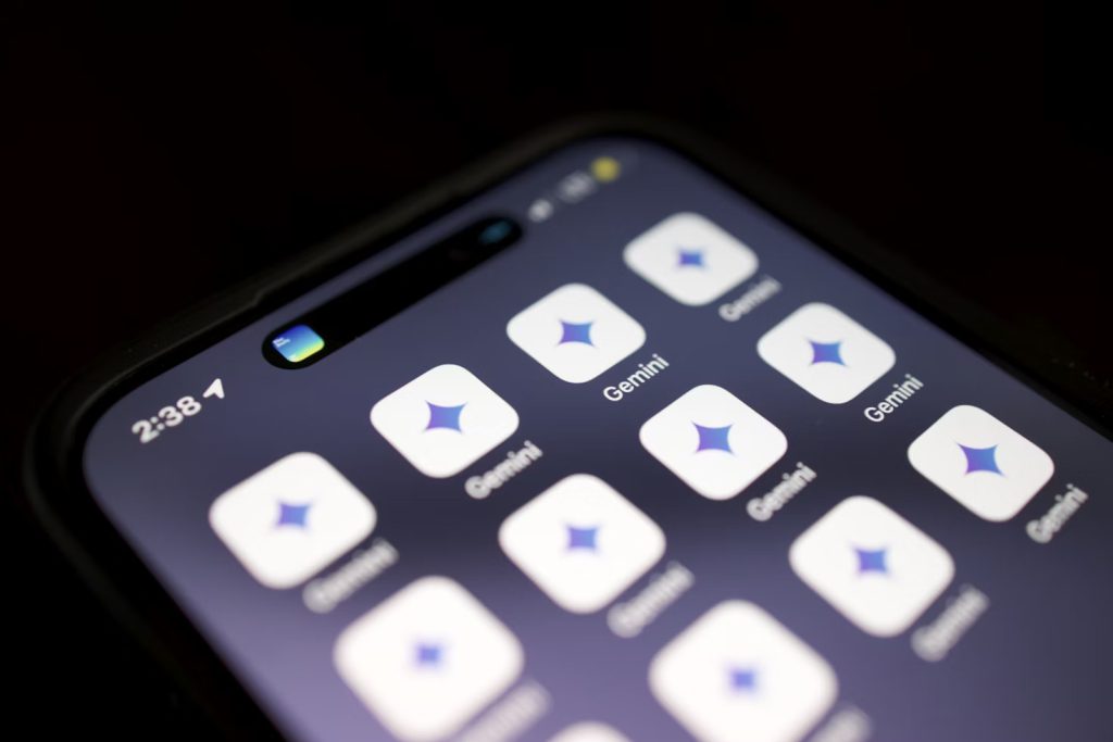 A close-up, slightly angled view of a smartphone screen displaying multiple instances of the Gemini app icon (a purple star-like shape on a light square background), suggesting a focus on a specific digital tool or platform.