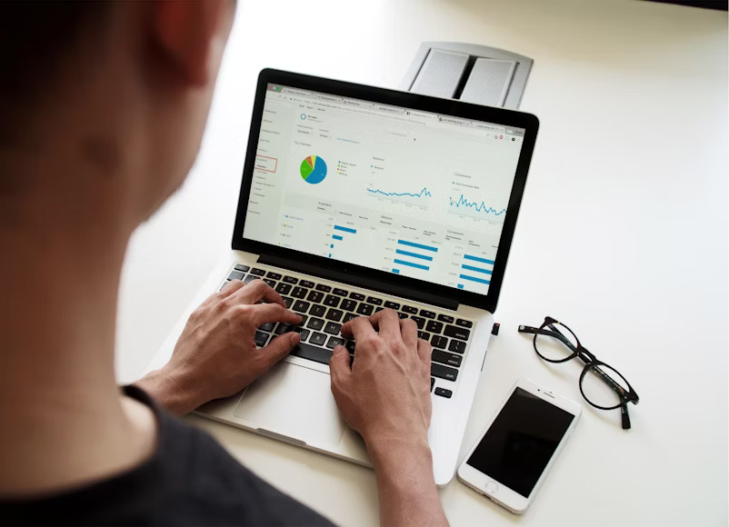 A person working on a laptop displaying Google Analytics, illustrating the data-driven nature of SEO and its impact on website performance.